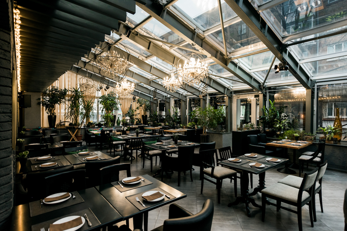 view of stylish empty cafe with arranged tables and chairs for visitors