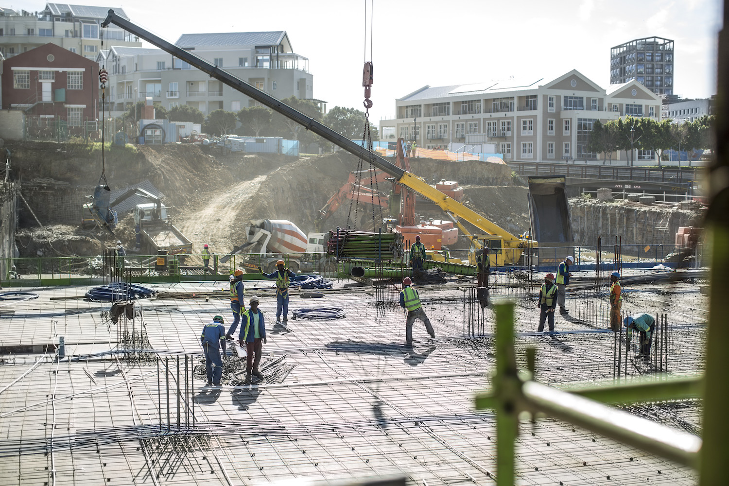 Construction workers laying foundation of building